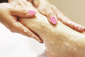 Massaging foot with salt scrub.